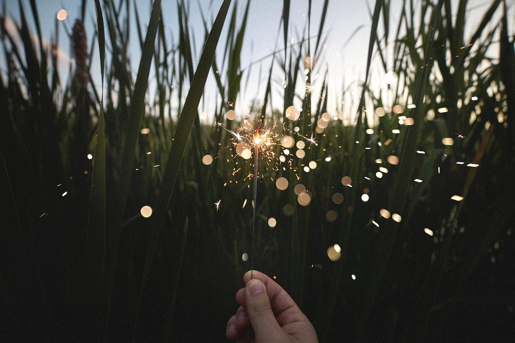 Colorful fireworks lighting up night sky above festival crowd