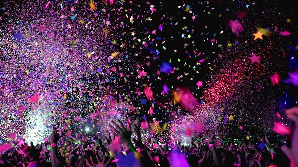 Concert stage with dramatic lighting and crowd silhouettes